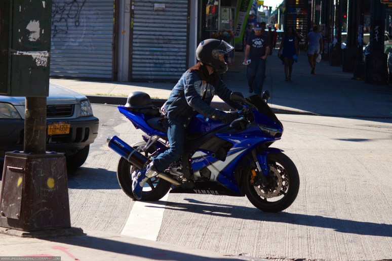 Person on Yamaha motorcycle crossing a Brooklyn street across Broadway.